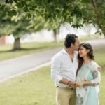 romantic couple embracing in a lush park setting