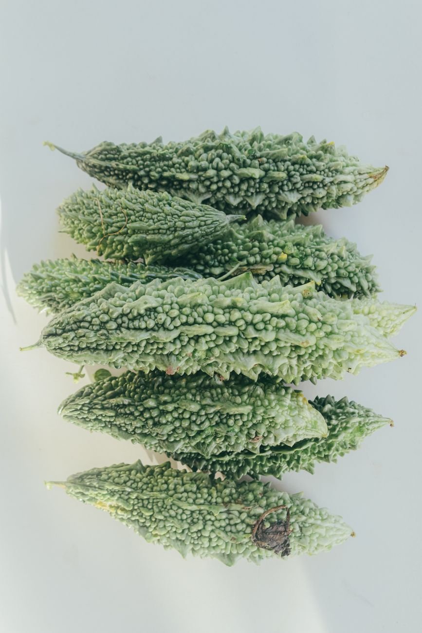 top view of fresh bitter melons on white surface