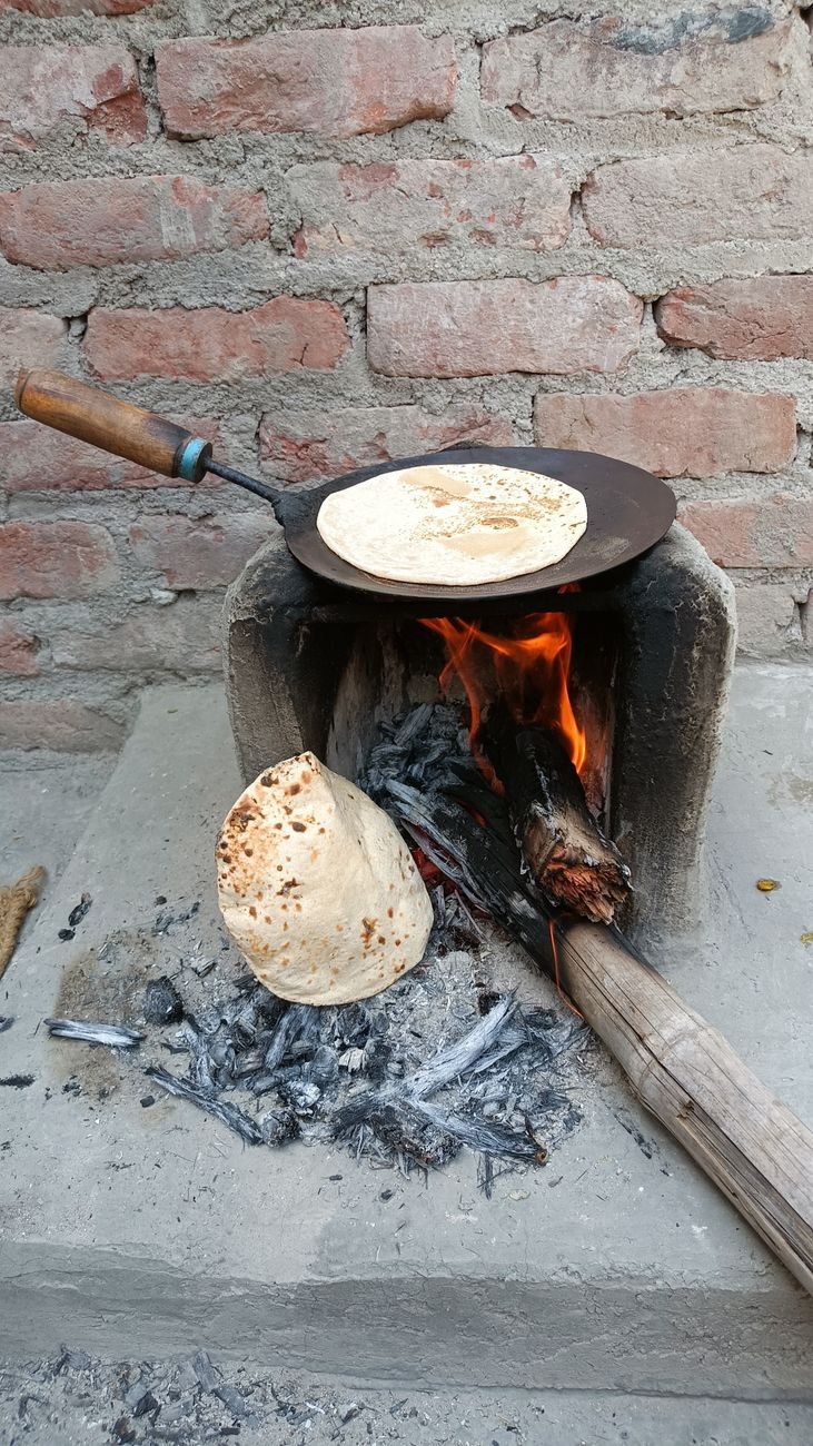 traditional indian flatbread cooking on open fire