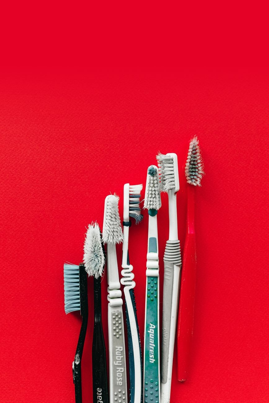 used toothbrushes on red surface