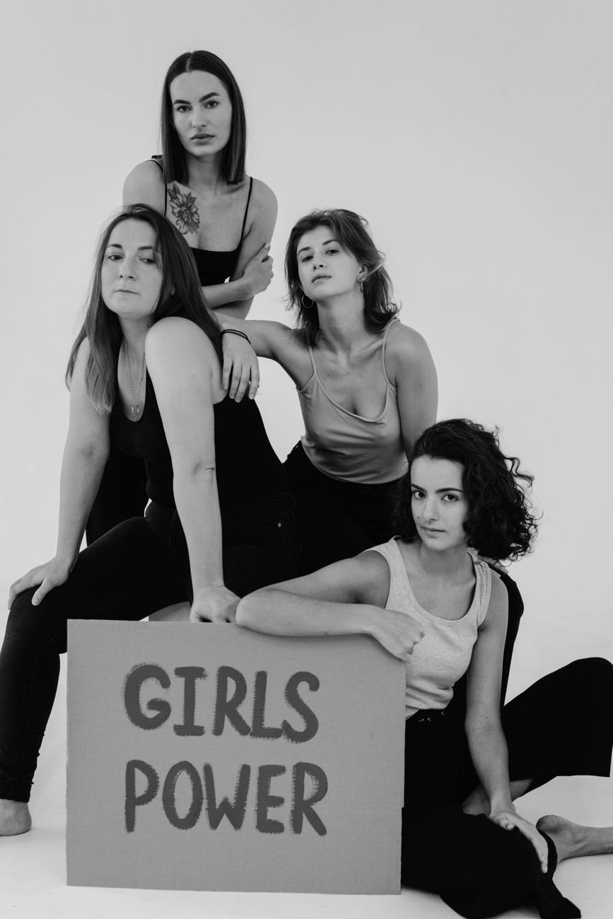 group of women in tank tops posing