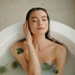 a woman in white bathtub with water