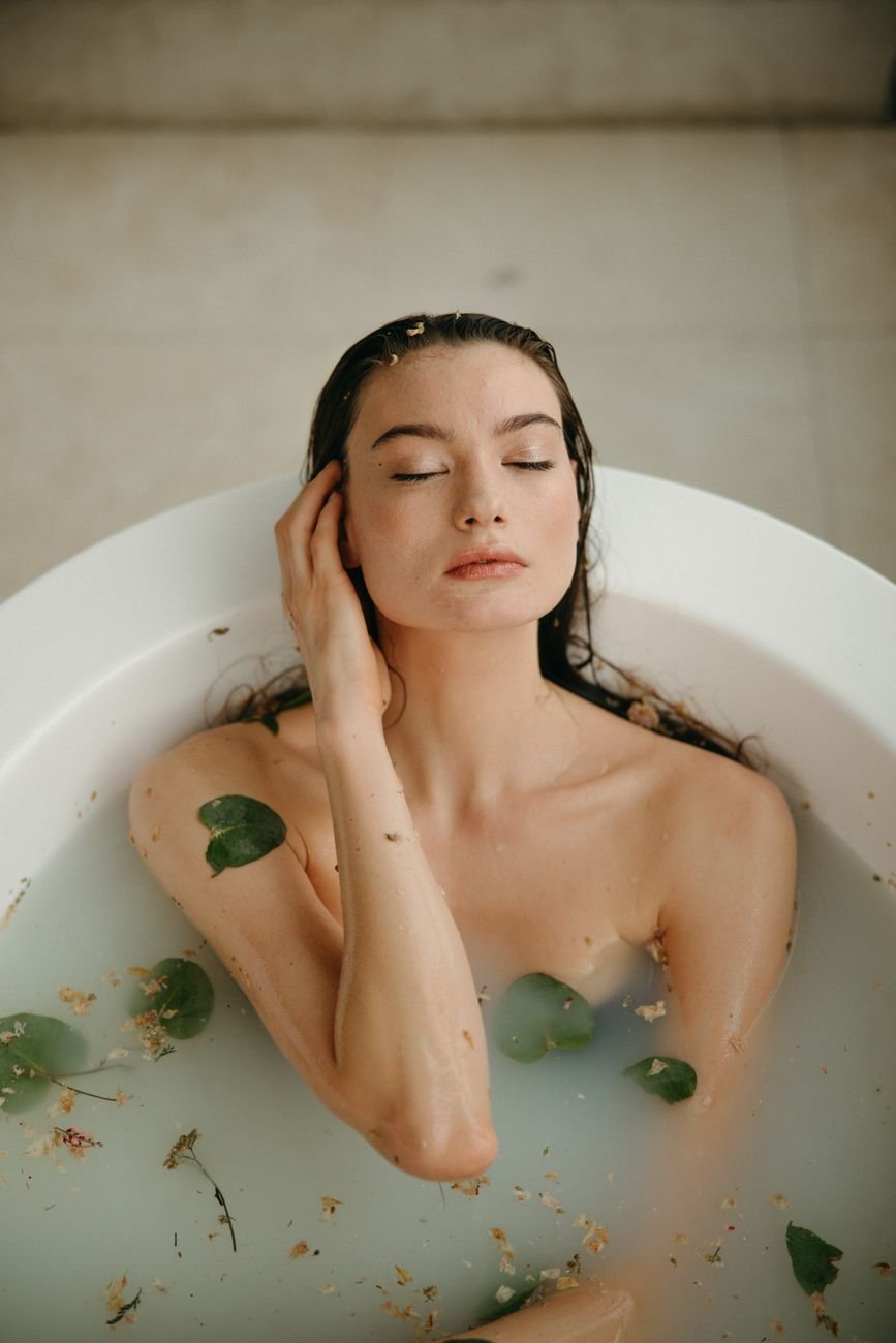 a woman in white bathtub with water