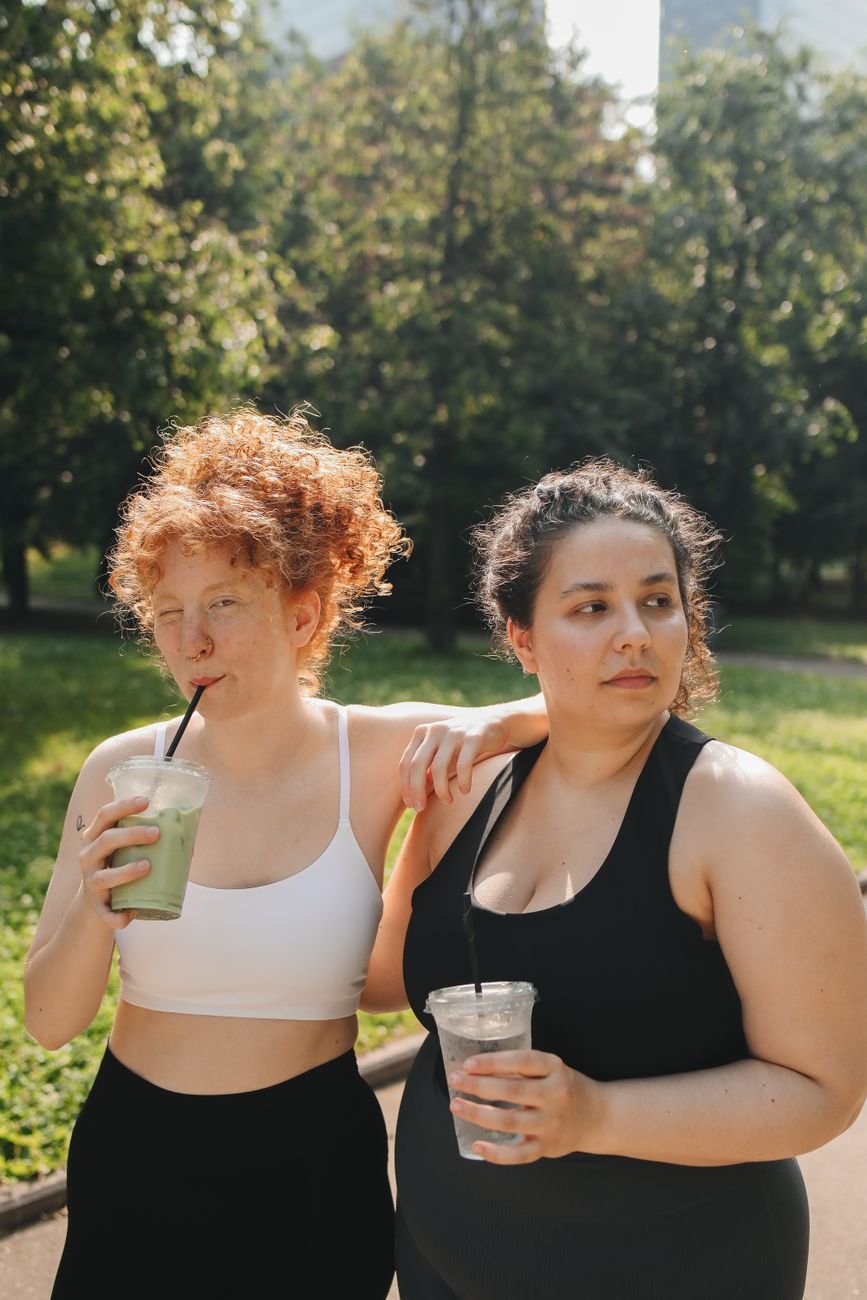 two women holding beverages